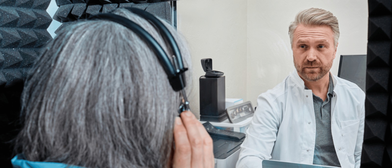 Man at clinic getting a hearing check-up to prevent hearing loss and protect ears from loud noise